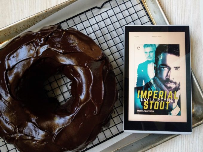 Chococlate bundt cake with ganache and Kindle with ebook cover of Imperial Stout by Layla Reyne featuriing two men in suits on the cover